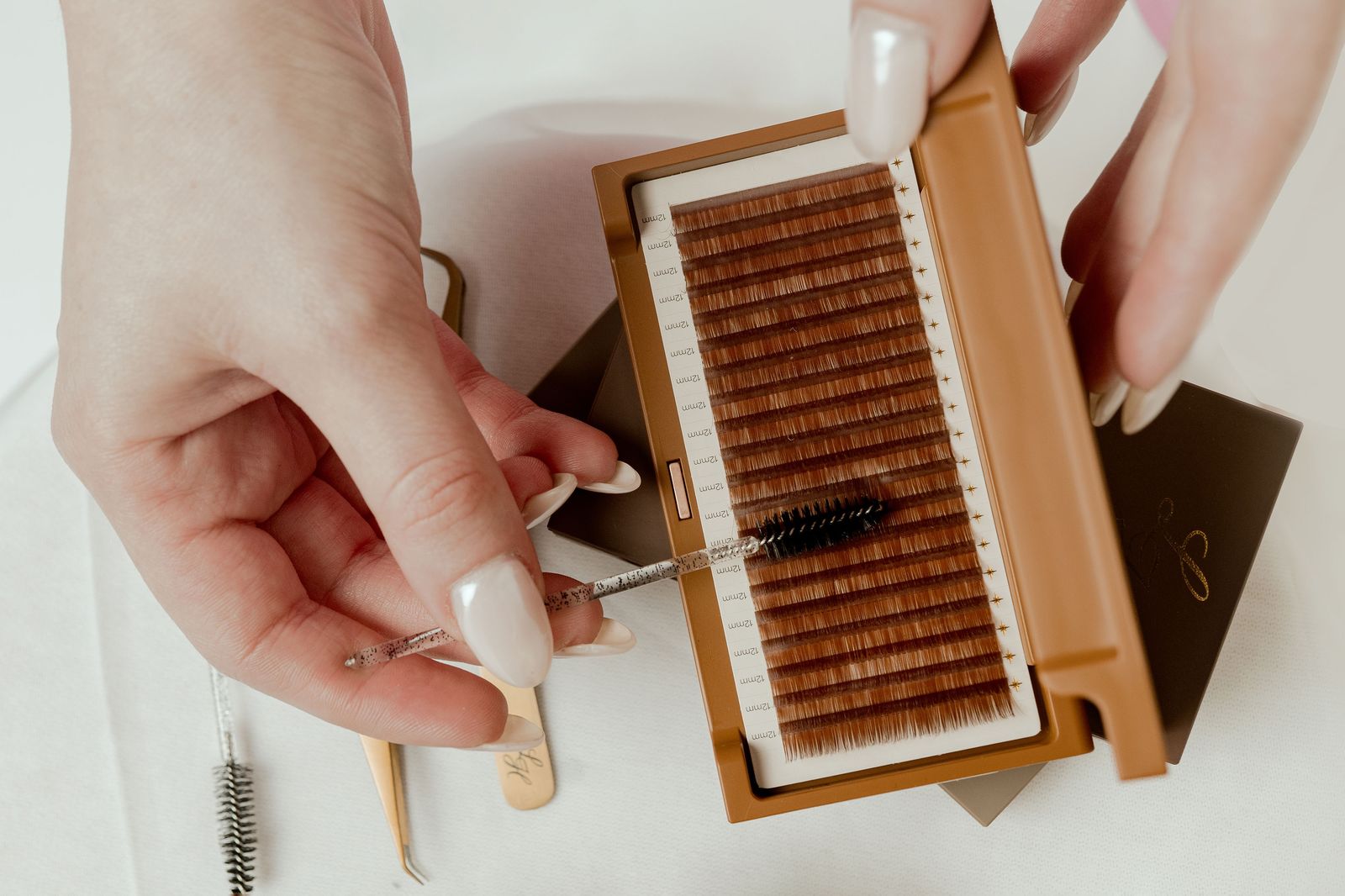 Caramel lash extension tray being brushed